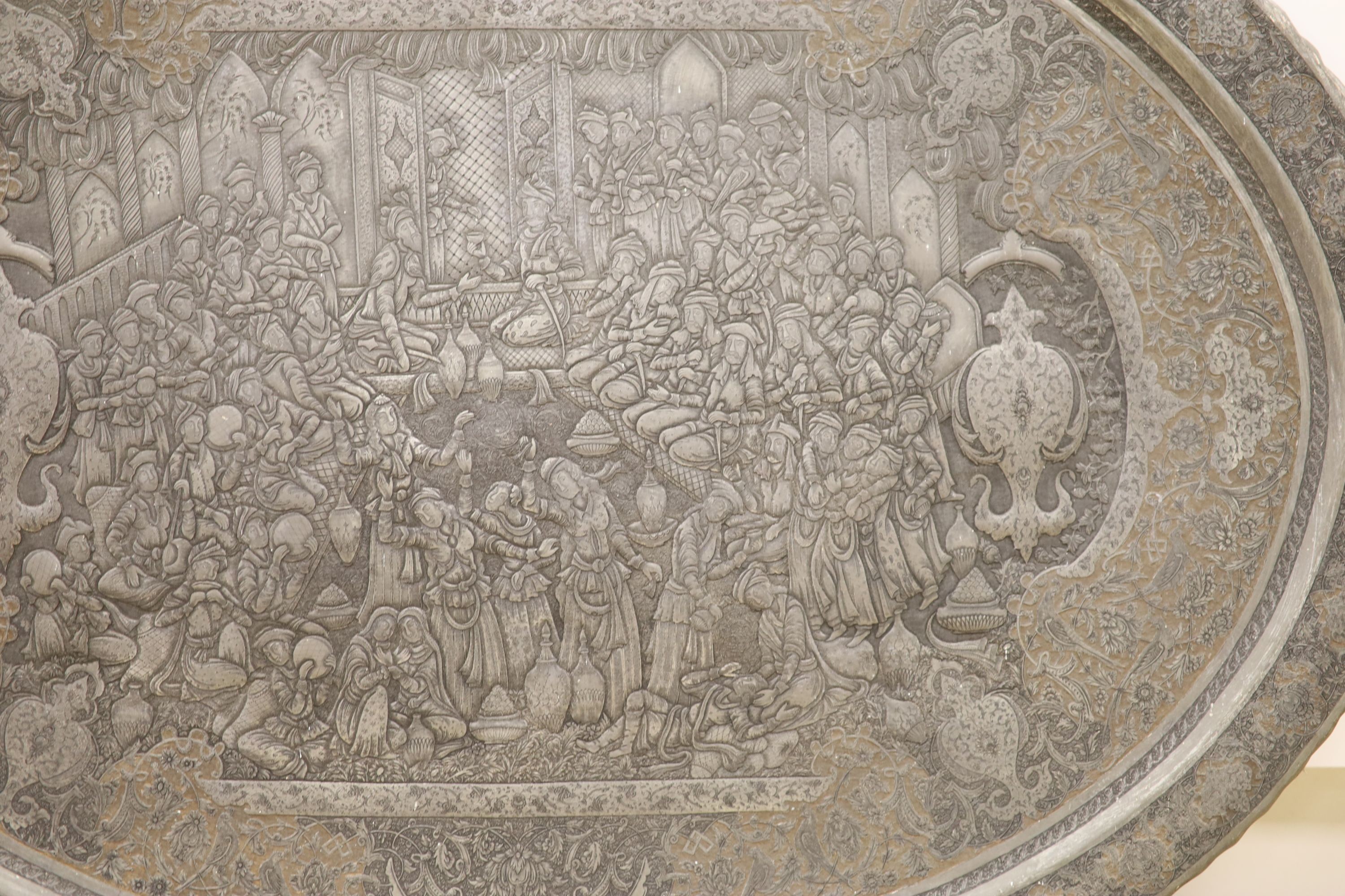 A large early 20th century Persian tinned and gilded repouse work wall plaque, 114cm across